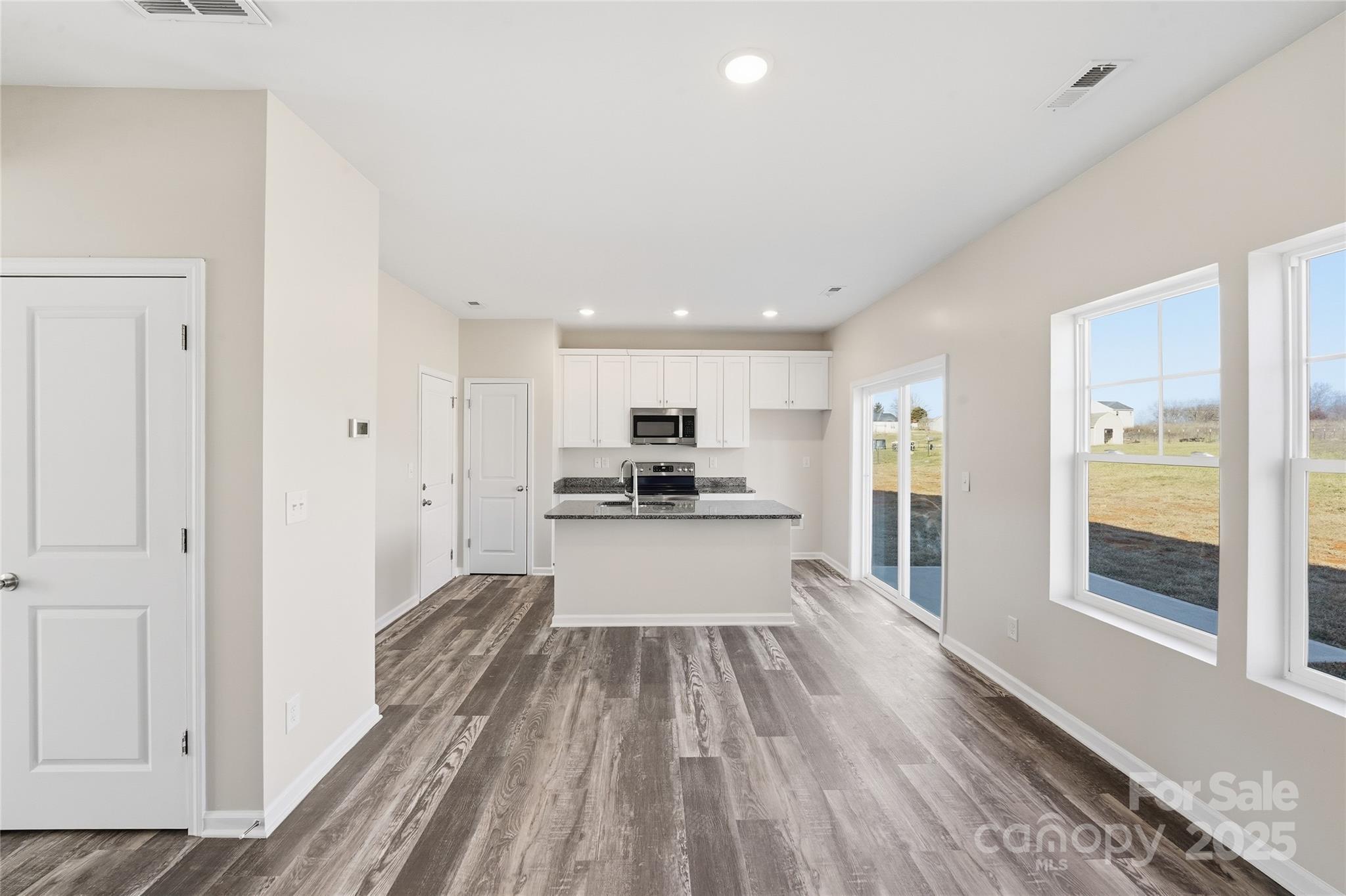 1532 Null Road Lincolnton, NC 28092 - Photo 23 of 32 a view of a kitchen with kitchen island wooden floor center island and windows