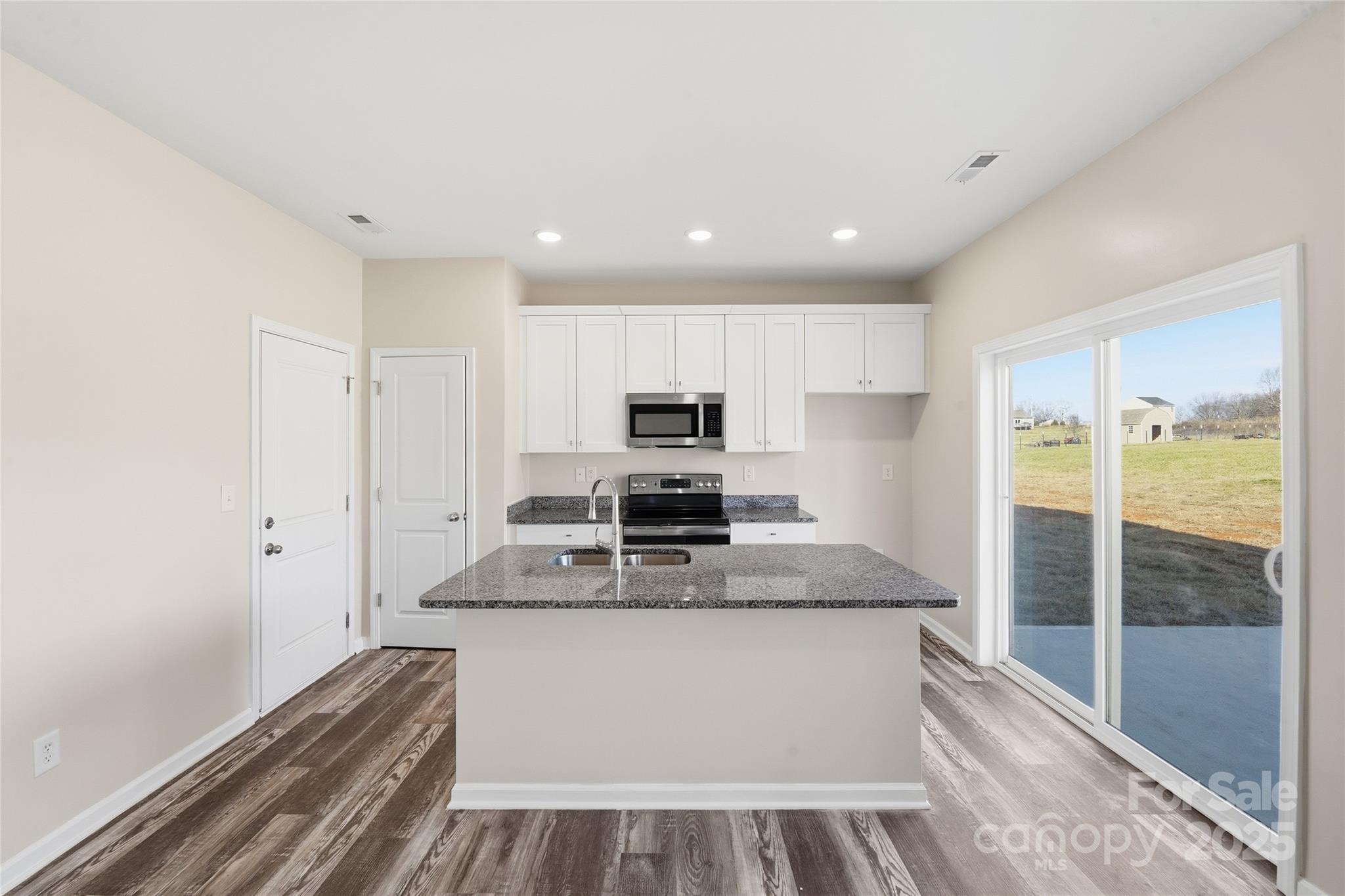 1532 Null Road Lincolnton, NC 28092 - Photo 5 of 32 a large kitchen with stainless steel appliances granite countertop a stove and a refrigerator