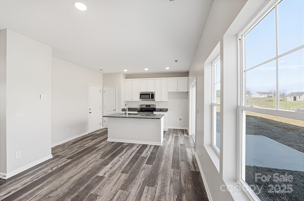 1532 Null Road Lincolnton, NC 28092 - Photo 8 of 32 a kitchen with a refrigerator and white cabinets