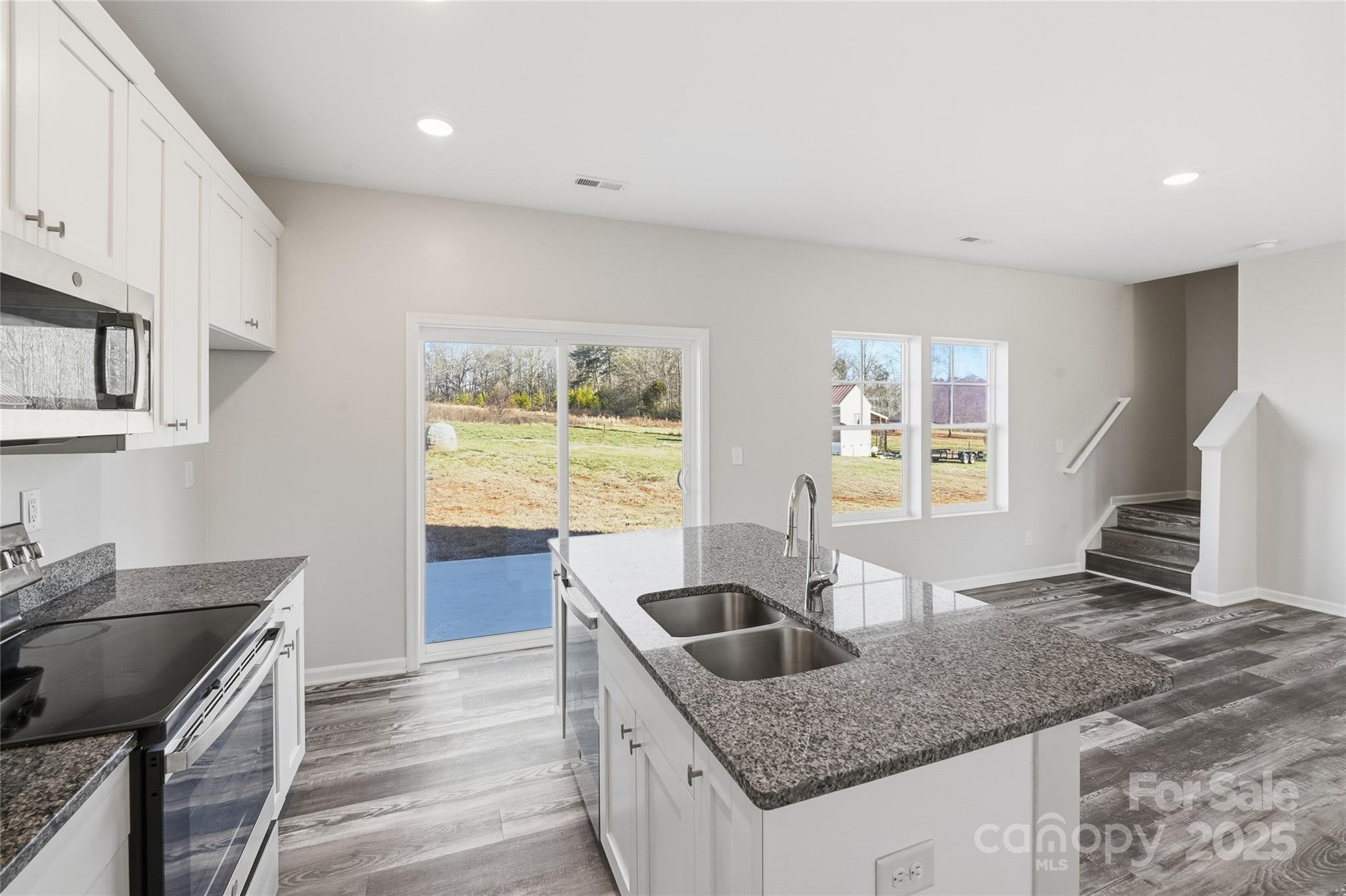 1532 Null Road Lincolnton, NC 28092 - Photo 9 of 32 a kitchen with granite countertop a sink a stove and cabinets