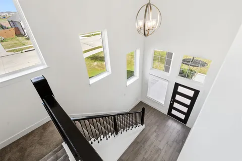 a view of staircase with white walls and a window
