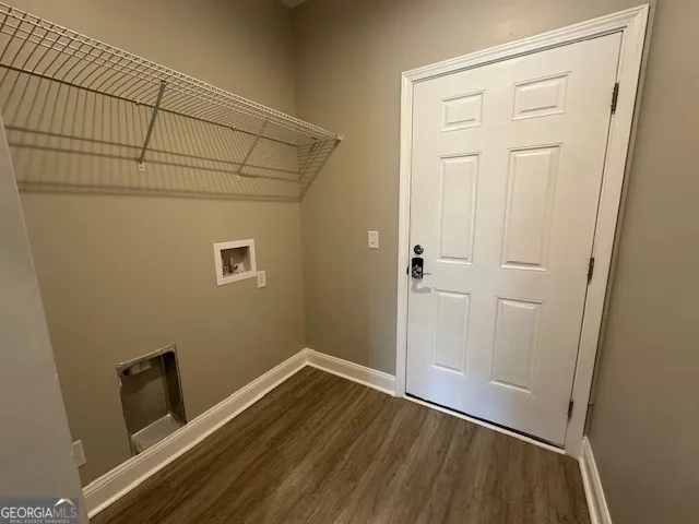 a view of small space with wooden floor and closet