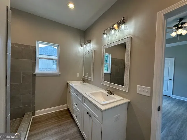 a bathroom with a double vanity sink and a mirror
