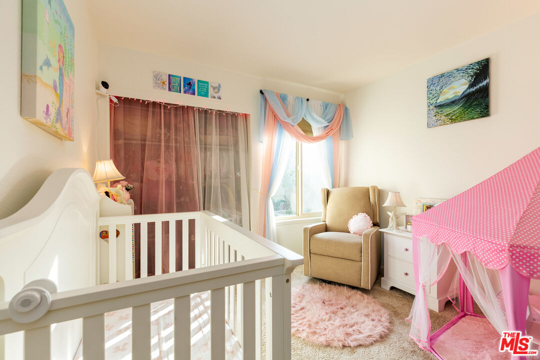 1754 Sinaloa Road, Unit 274 Simi Valley, CA 93065 - Photo 14 of 23 a living room with furniture and a baby crib