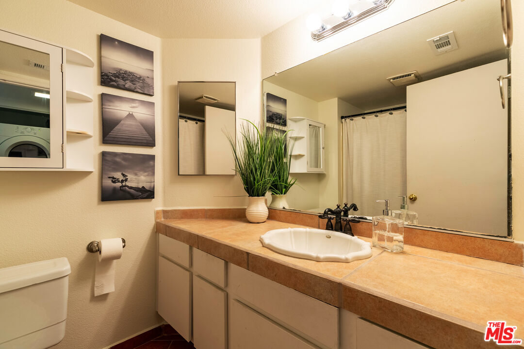 1754 Sinaloa Road, Unit 274 Simi Valley, CA 93065 - Photo 15 of 23 a bathroom with a granite countertop sink and a mirror