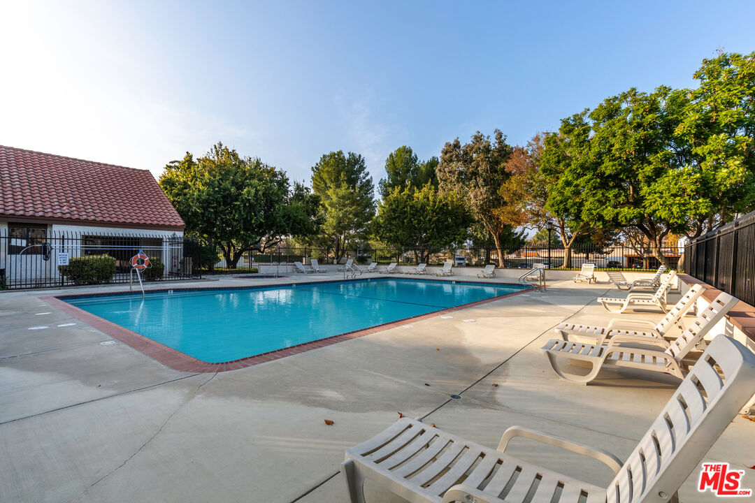 1754 Sinaloa Road, Unit 274 Simi Valley, CA 93065 - Photo 16 of 23 a view of swimming pool with outdoor seating and trees in the background