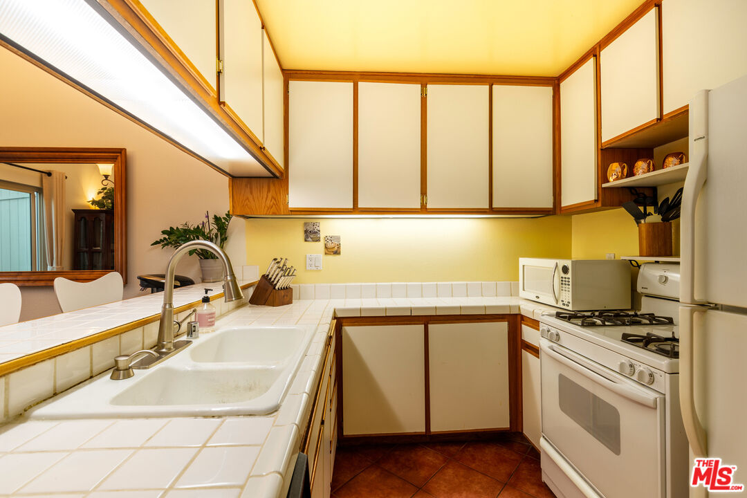 1754 Sinaloa Road, Unit 274 Simi Valley, CA 93065 - Photo 6 of 23 a kitchen with a sink stove and cabinets