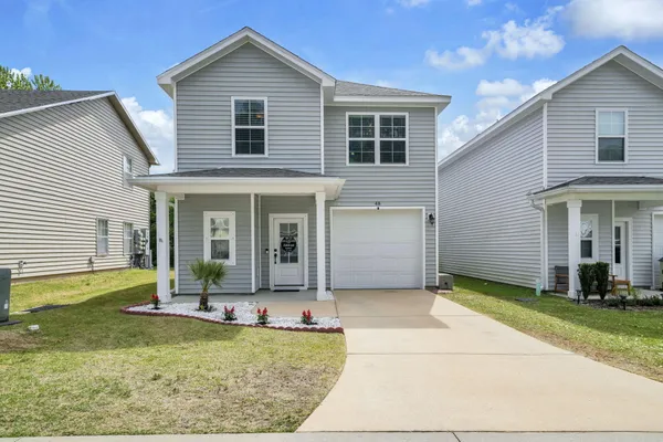 a front view of a house with garden