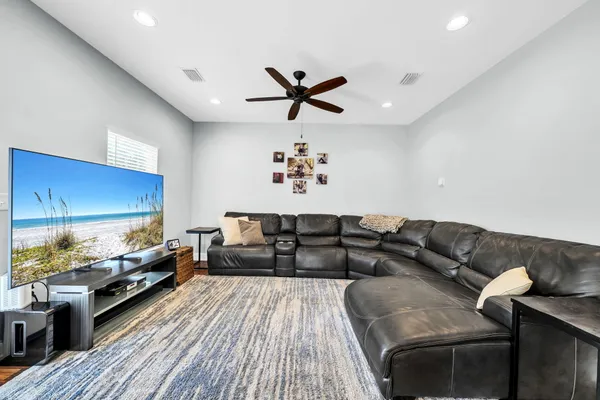 a living room with furniture and a wooden floor