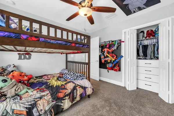 a bedroom with furniture and a book shelf