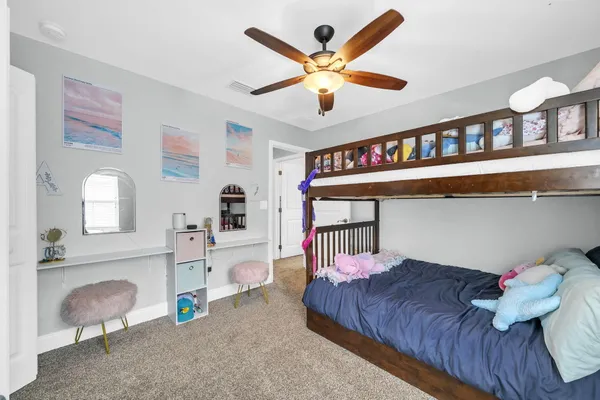 a bedroom with furniture and a large window