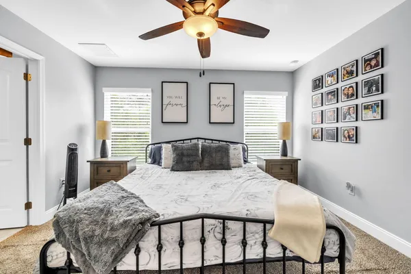 a bedroom with a bed and a table with a chandelier