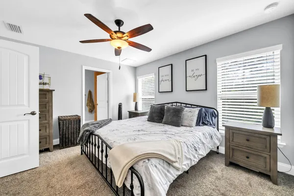 a bedroom with a bed and a chandelier