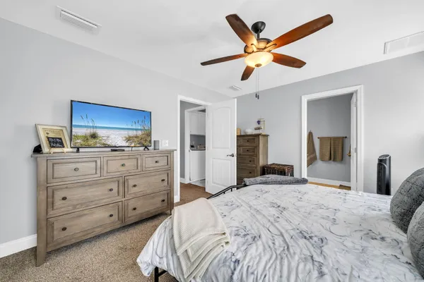 a bedroom with a large bed and a ceiling fan