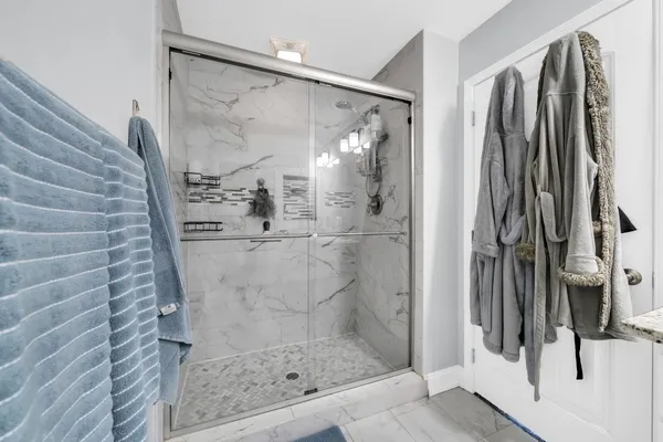 a bathroom with a glass shower door