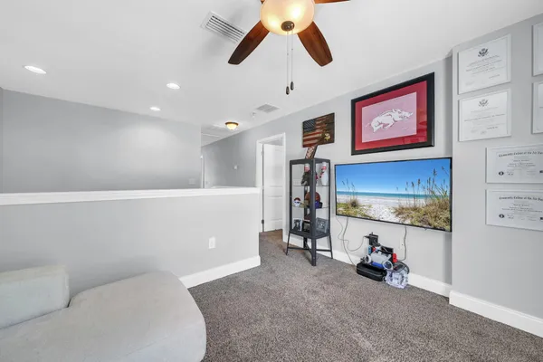 a view of a livingroom with shelves and workspace