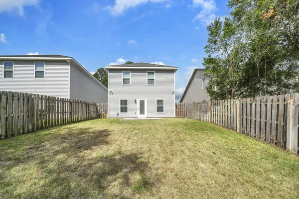 a view of a house with a backyard