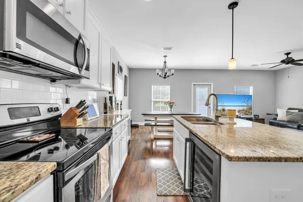a kitchen with granite countertop a stove and a sink