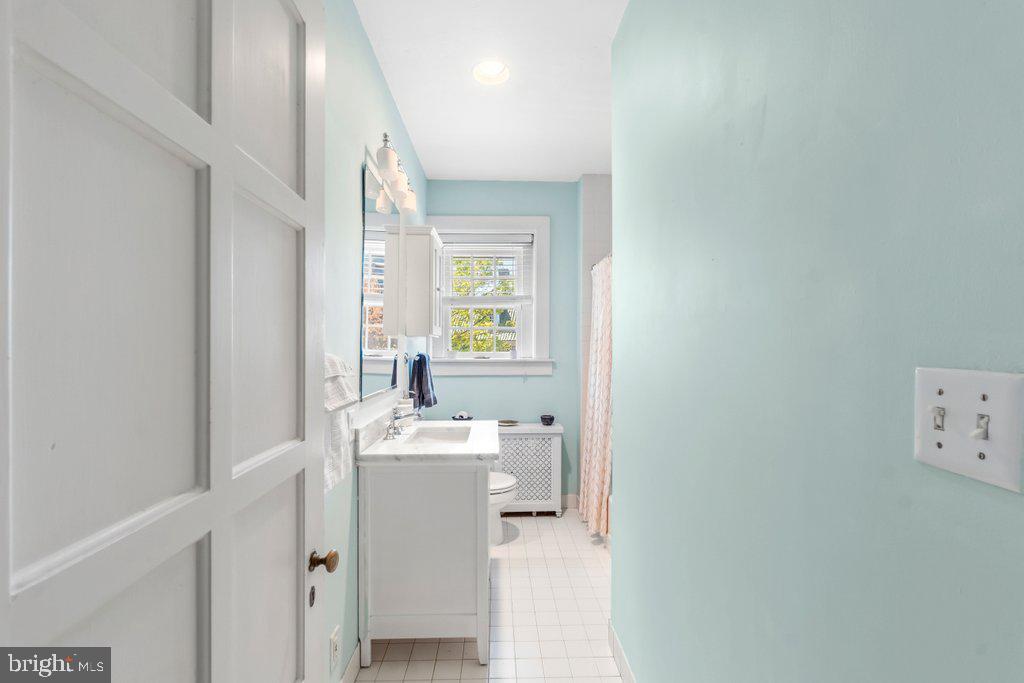 2 East Highfield Road Baltimore, MD 21218 - Photo 29 of 46 a bathroom with a sink a mirror and a bathtub