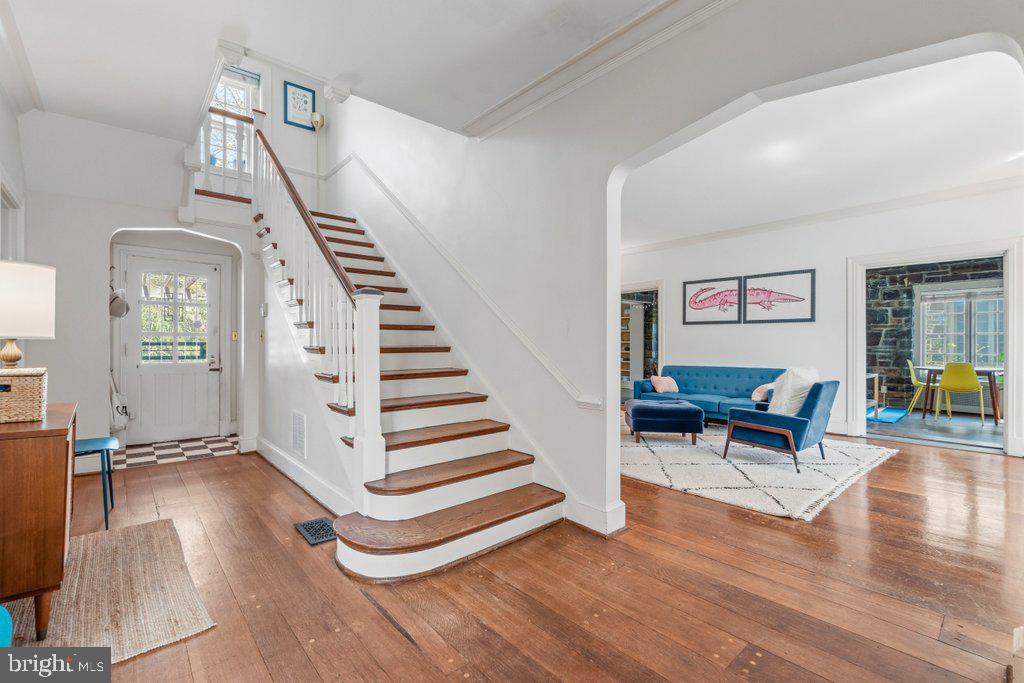 2 East Highfield Road Baltimore, MD 21218 - Photo 5 of 46 a view of a livingroom with wooden floor and stairs