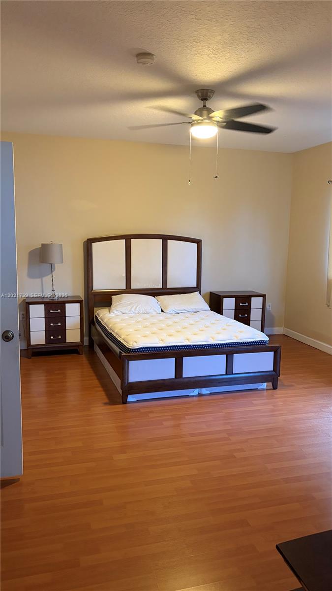 13553 Southwest 124th Avenue Road Miami, FL 33186 - Photo 20 of 31 a bed room with a bed and a night stand