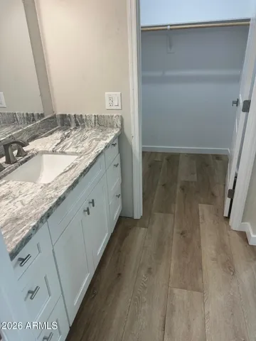 a bathroom with a granite countertop sink and a mirror