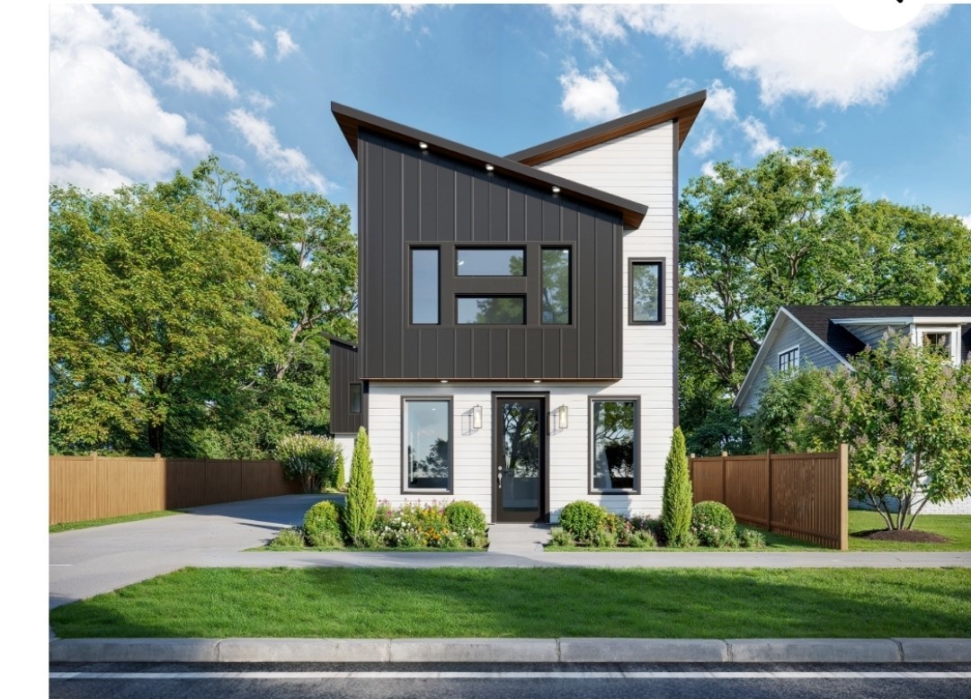 a front view of a house with a yard and potted plants