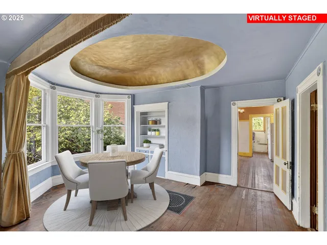 a view of a dining room with furniture wooden floor and a large window