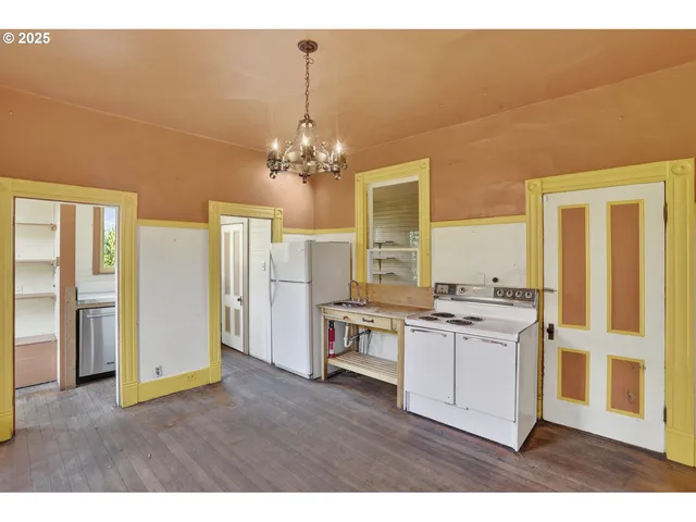 a kitchen with stainless steel appliances granite countertop a stove and a refrigerator