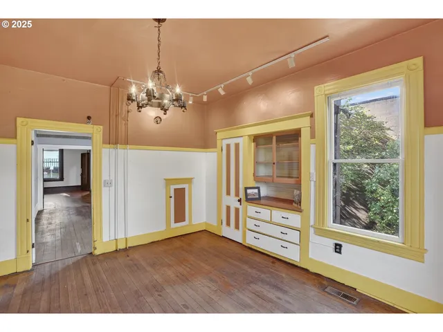 a view interior of a house with wooden floor a fireplace a chandelier and windows