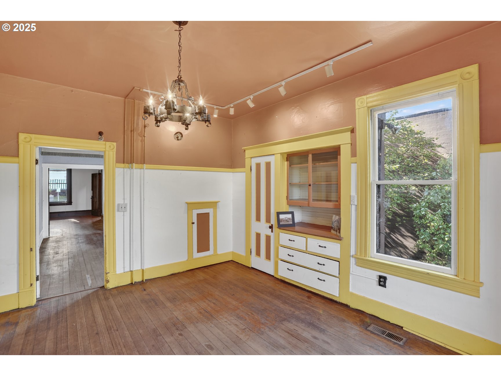 280 South 1st Street St. Helens, OR 97051 - Photo 13 of 41 a view interior of a house with wooden floor a fireplace a chandelier and windows