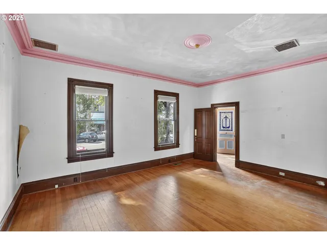 a view interior of an empty room with window and wooden floor