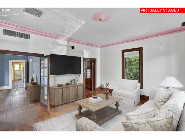 a living room with furniture and a flat screen tv