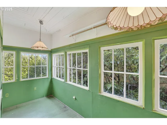 a living room with a window and ceiling fan
