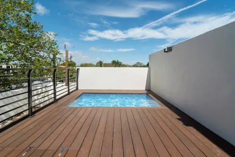a view of a balcony with wooden floor