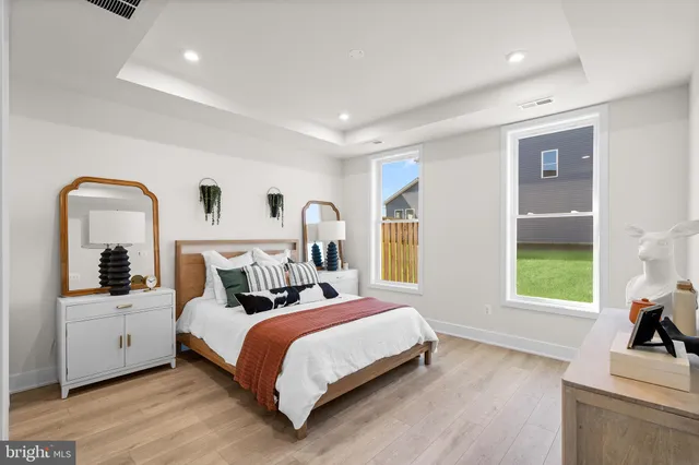 a bedroom with a bed and a large window