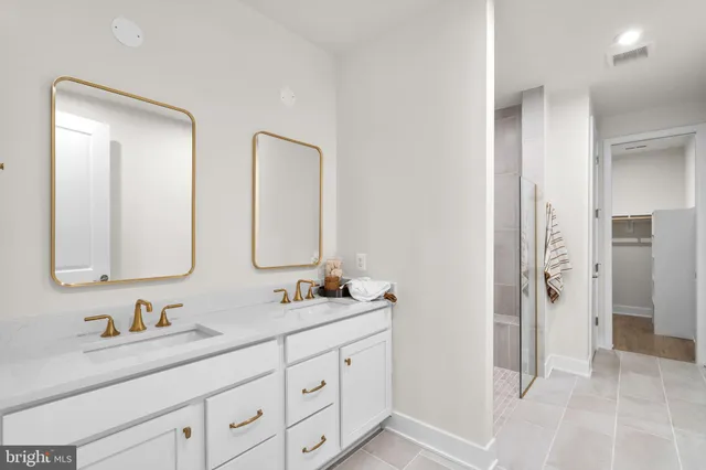 a bathroom with double sink and a mirror