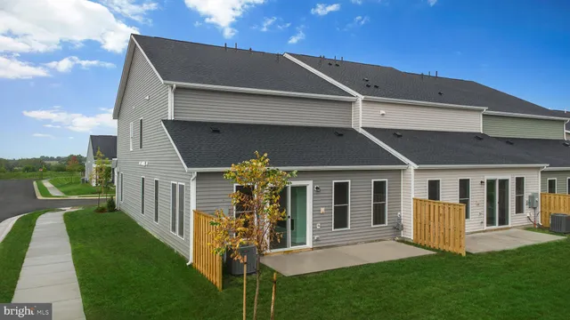 a front view of a house with a yard table and chairs