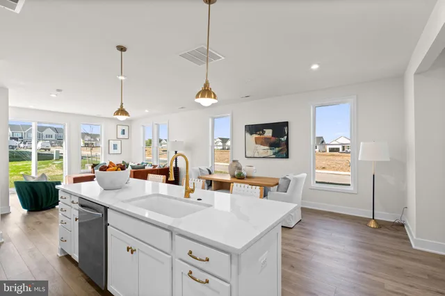 a kitchen with sink cabinets and wooden floor