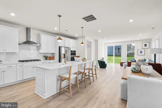 a large kitchen with cabinets a sink a counter space stainless steel appliances and cabinets