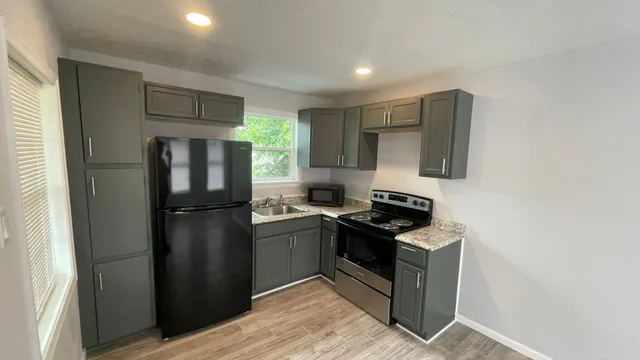 a kitchen with a refrigerator sink and stove