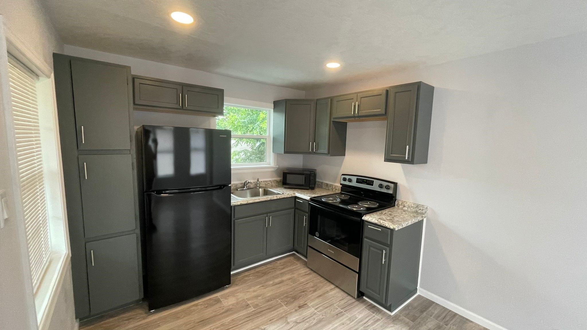 1723 Alta Vista Street, Unit A Houston, TX 77023 - Photo 1 of 7 a kitchen with a refrigerator sink and stove