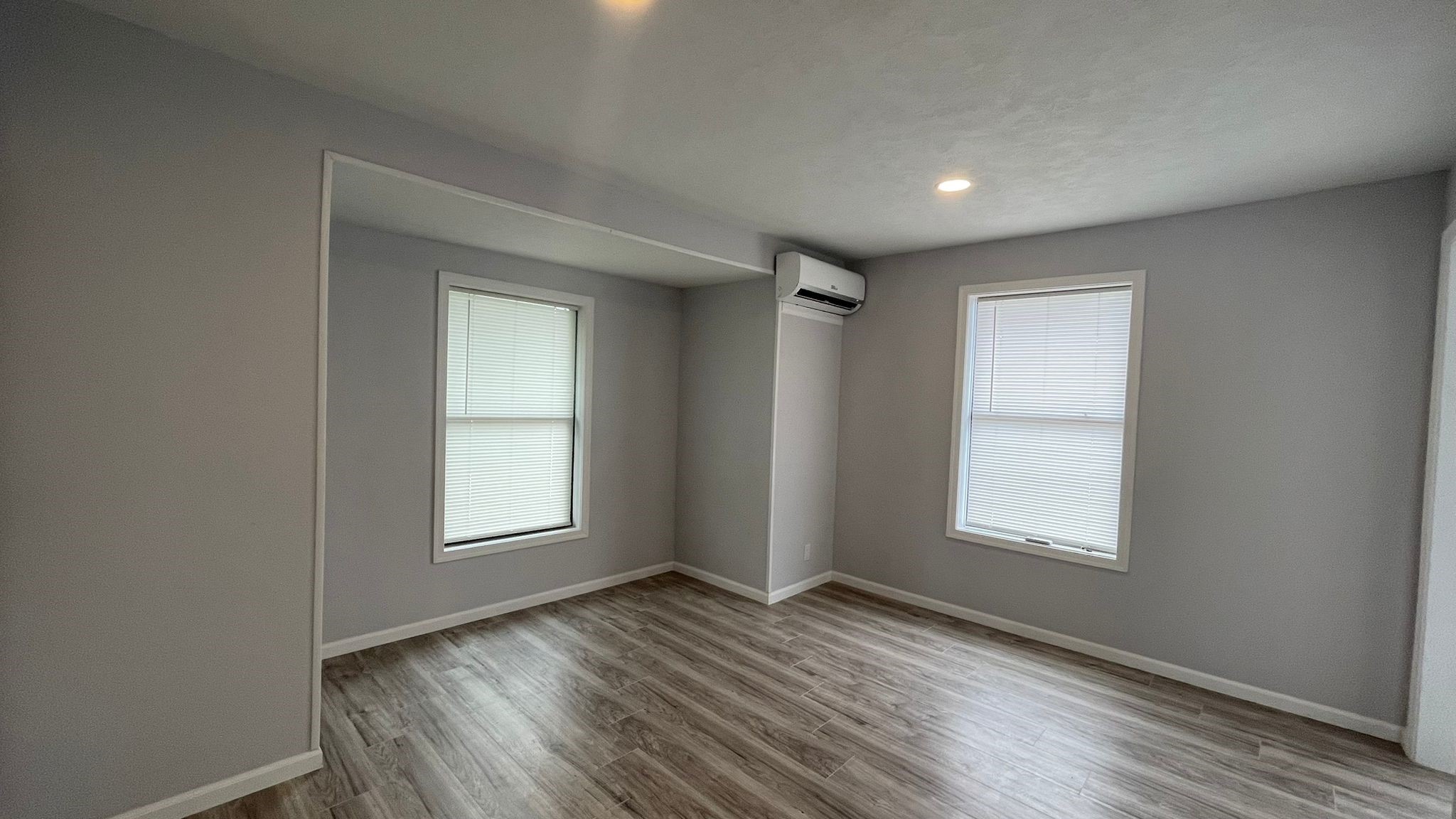 1723 Alta Vista Street, Unit A Houston, TX 77023 - Photo 4 of 7 an empty room with wooden floor and windows