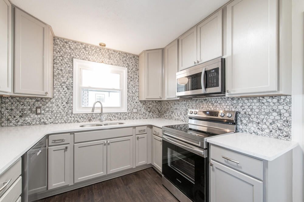 335 Indian Trail Augusta, GA 30907 - Photo 4 of 24 a kitchen with a sink stove and microwave