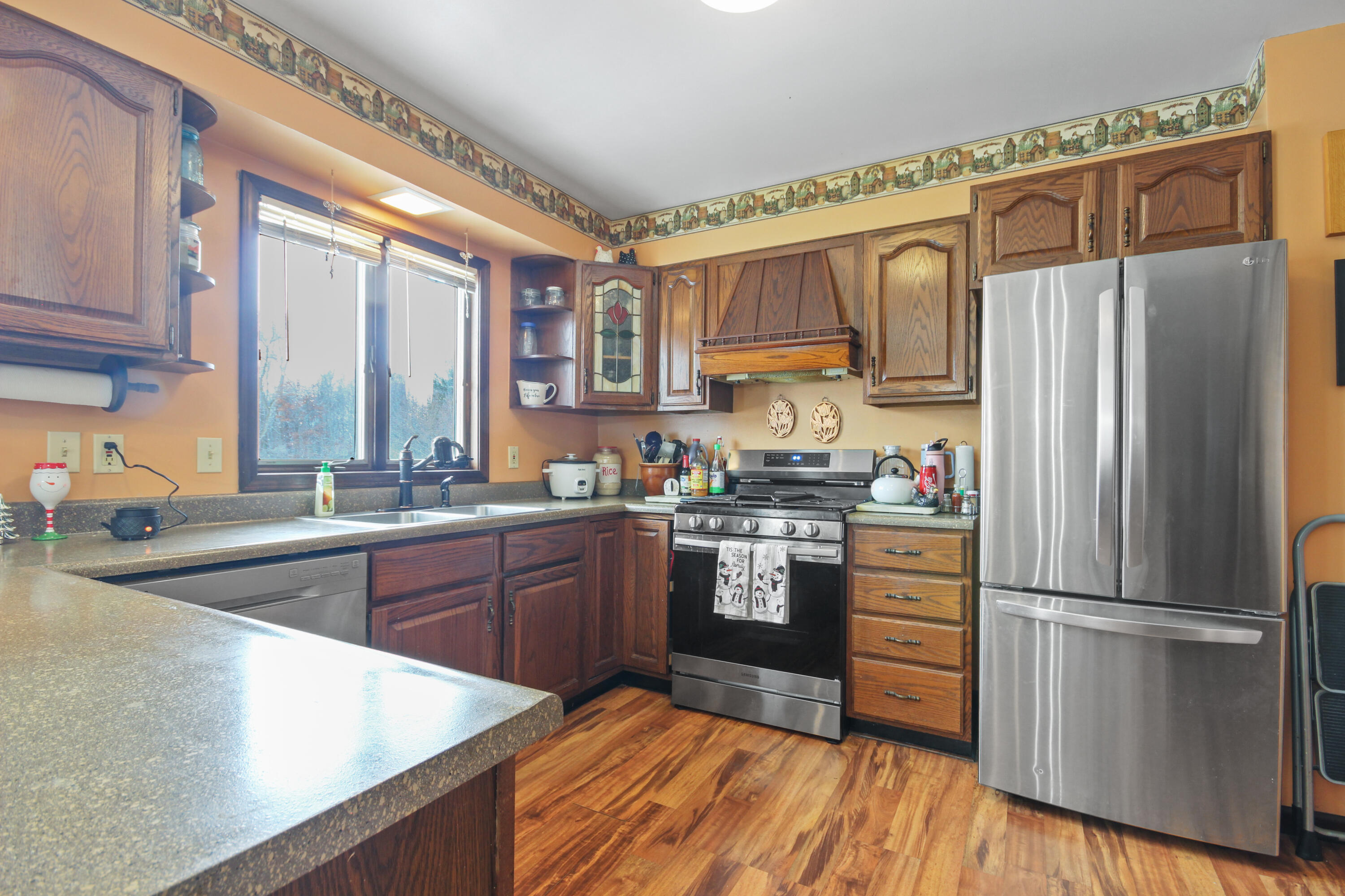 9272 Vigo Street Crown Point, IN 46307 - Photo 3 of 21 a kitchen with a refrigerator a sink and cabinets
