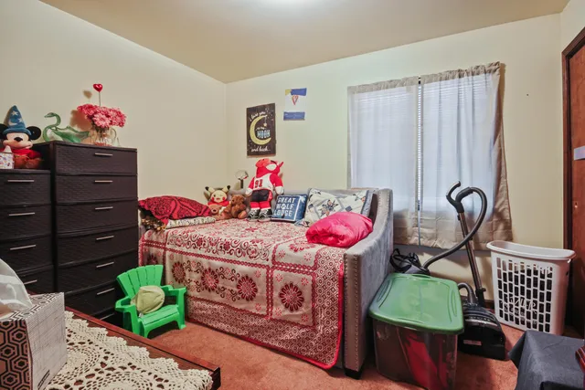 a bedroom with a bed cabinets and a dresser