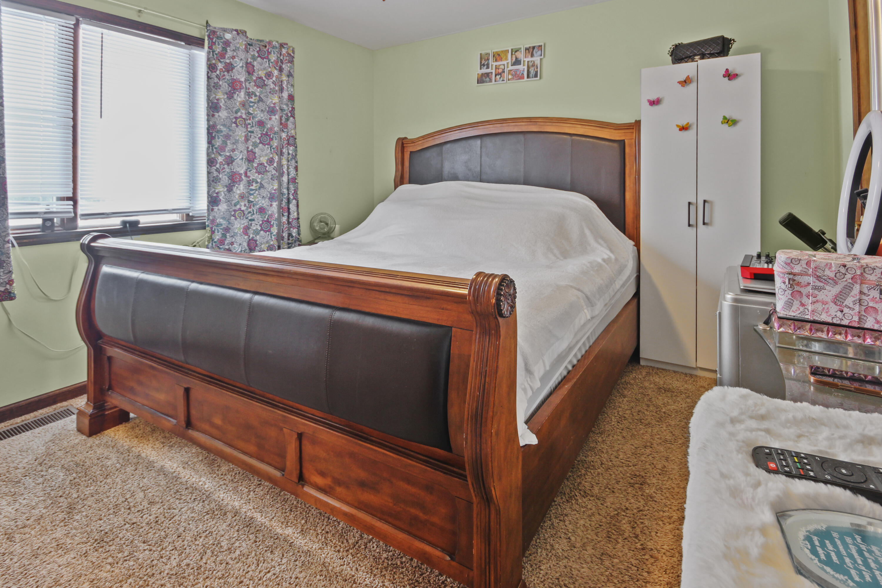 9272 Vigo Street Crown Point, IN 46307 - Photo 8 of 21 a bedroom with a bed and a flat tv screen on the dresser