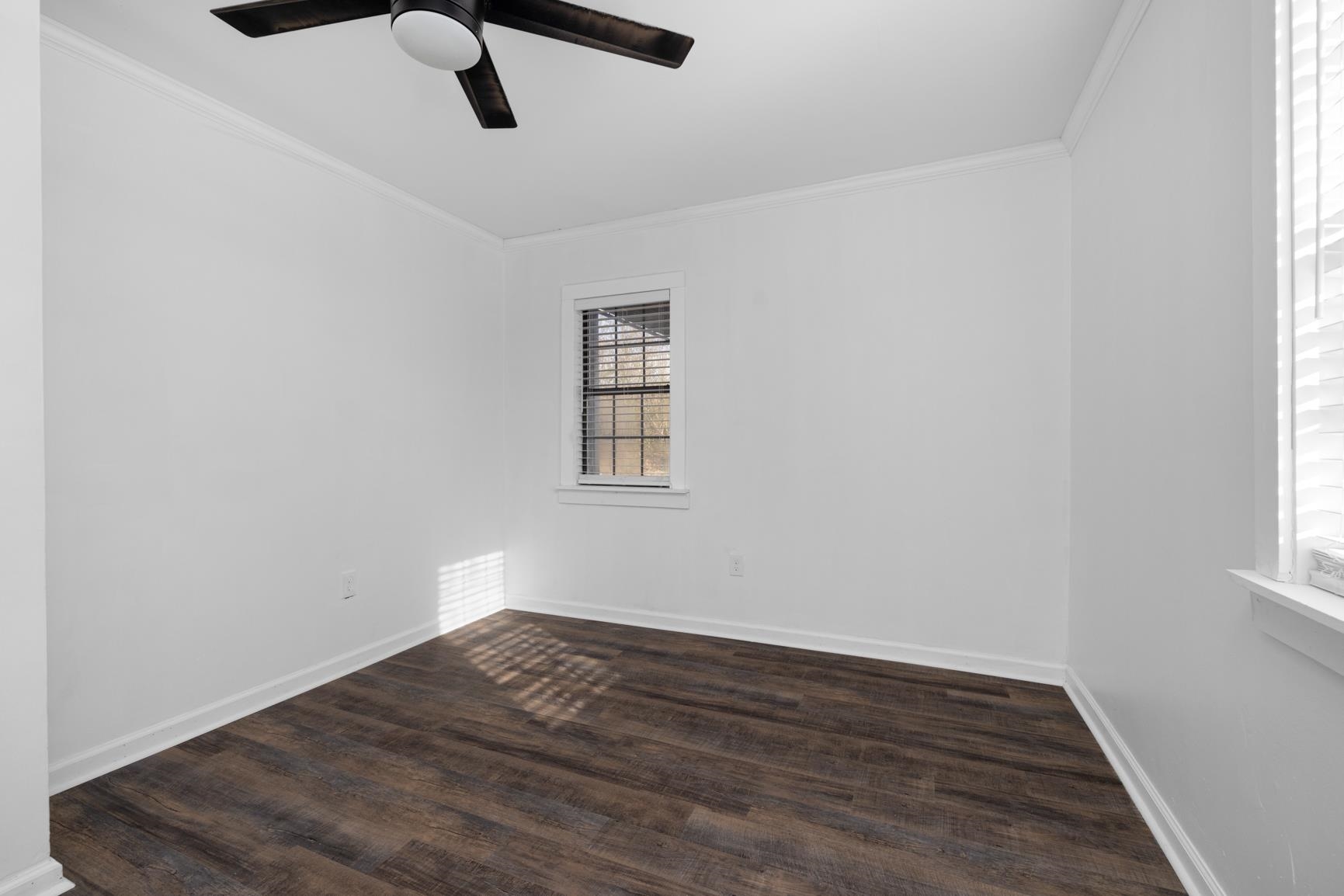 8424 Old Memphis Road Brighton, TN 38011 - Photo 17 of 29 an empty room with wooden floor cabinet and windows
