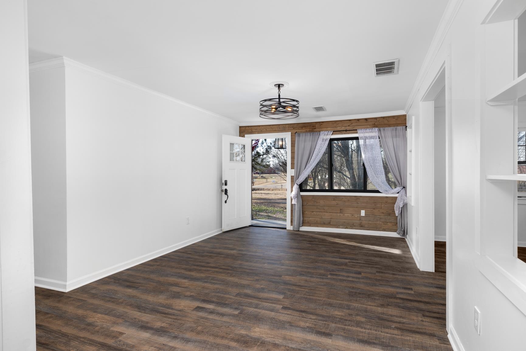 8424 Old Memphis Road Brighton, TN 38011 - Photo 25 of 29 a view of a room with wooden floor and a ceiling fan