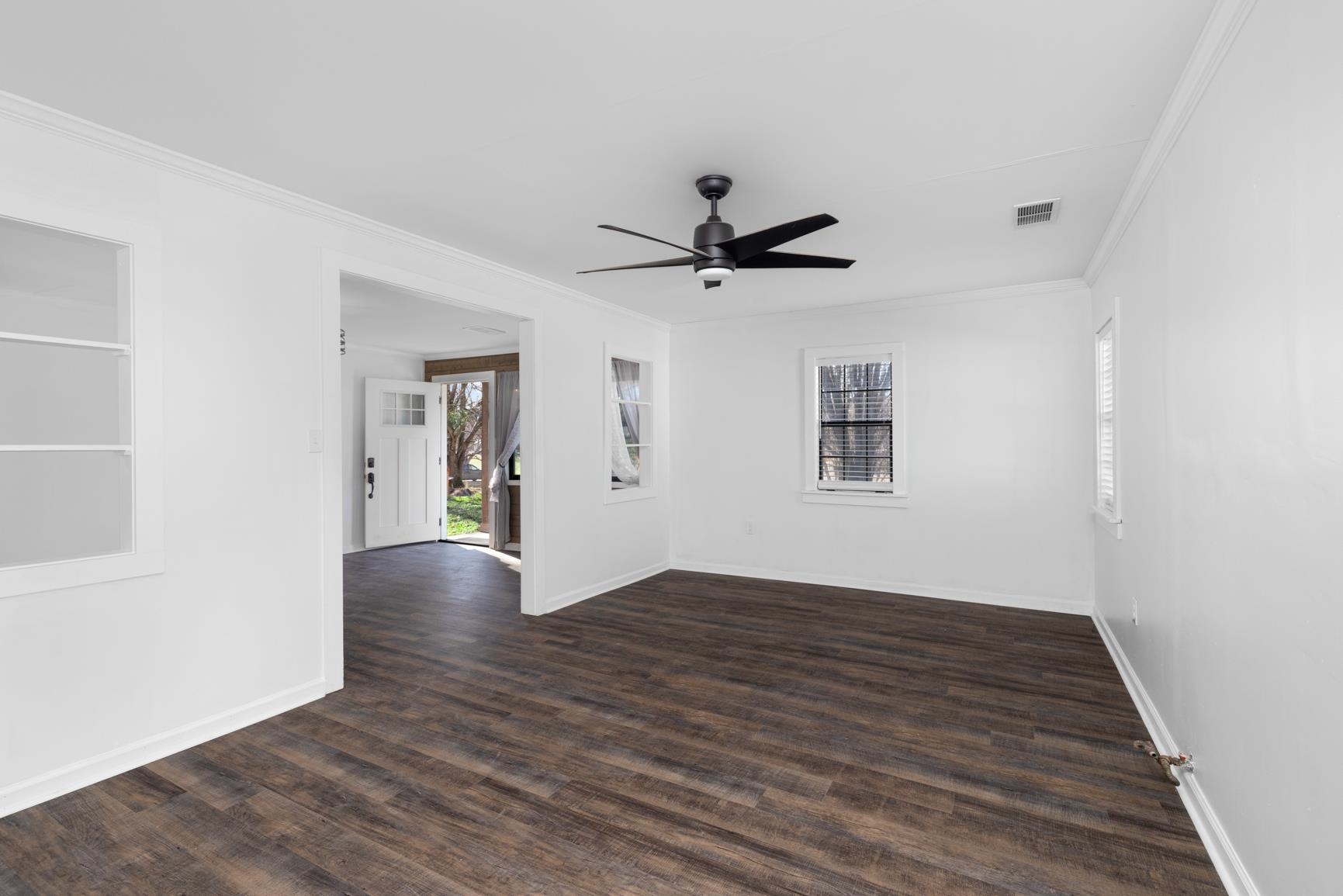 8424 Old Memphis Road Brighton, TN 38011 - Photo 27 of 29 a view of an empty room with wooden floor and a window